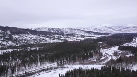 wide aerial view of alaska wilderness with road and cars, chena hot springs road