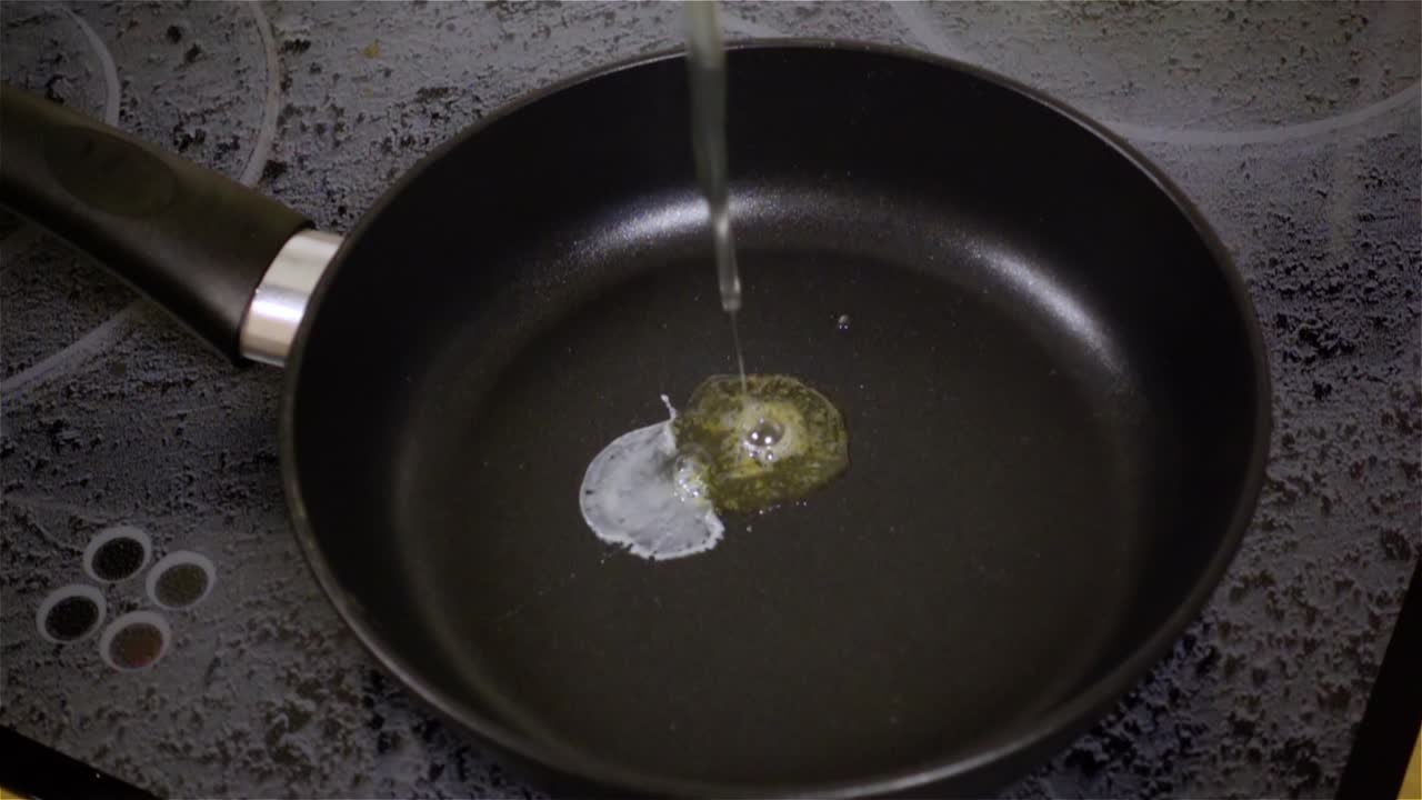 Fried egg. Raw egg on the frying pan in slow motion.