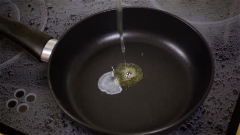 fried egg. raw egg on the frying pan in slow motion.