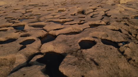 close-up view of a scenic seashore with huge flat rocks in the beautiful light of the setting sun, malta