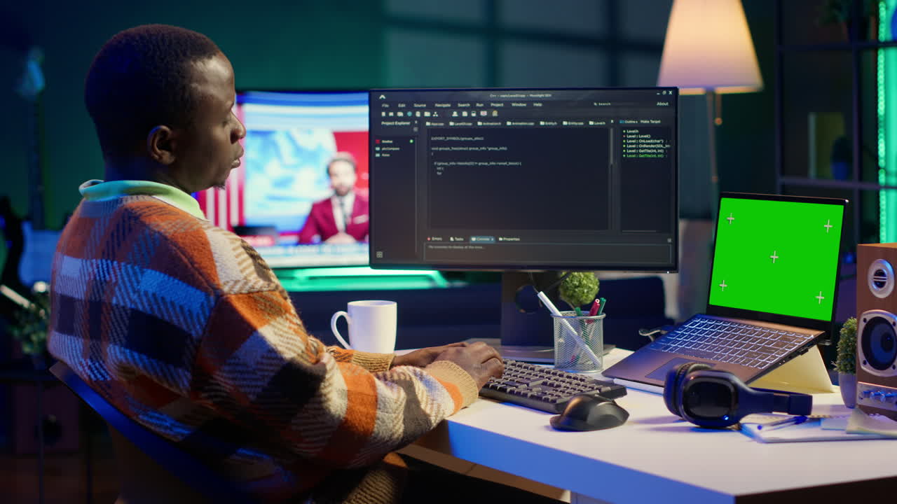 Man working on computer with green screen laptop