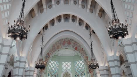 intricate ceiling of a cathedral with arched beams and ornate chandeliers