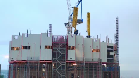 aerial view of the top of 443 queen street residential building construction site with cranes, brisbane australia