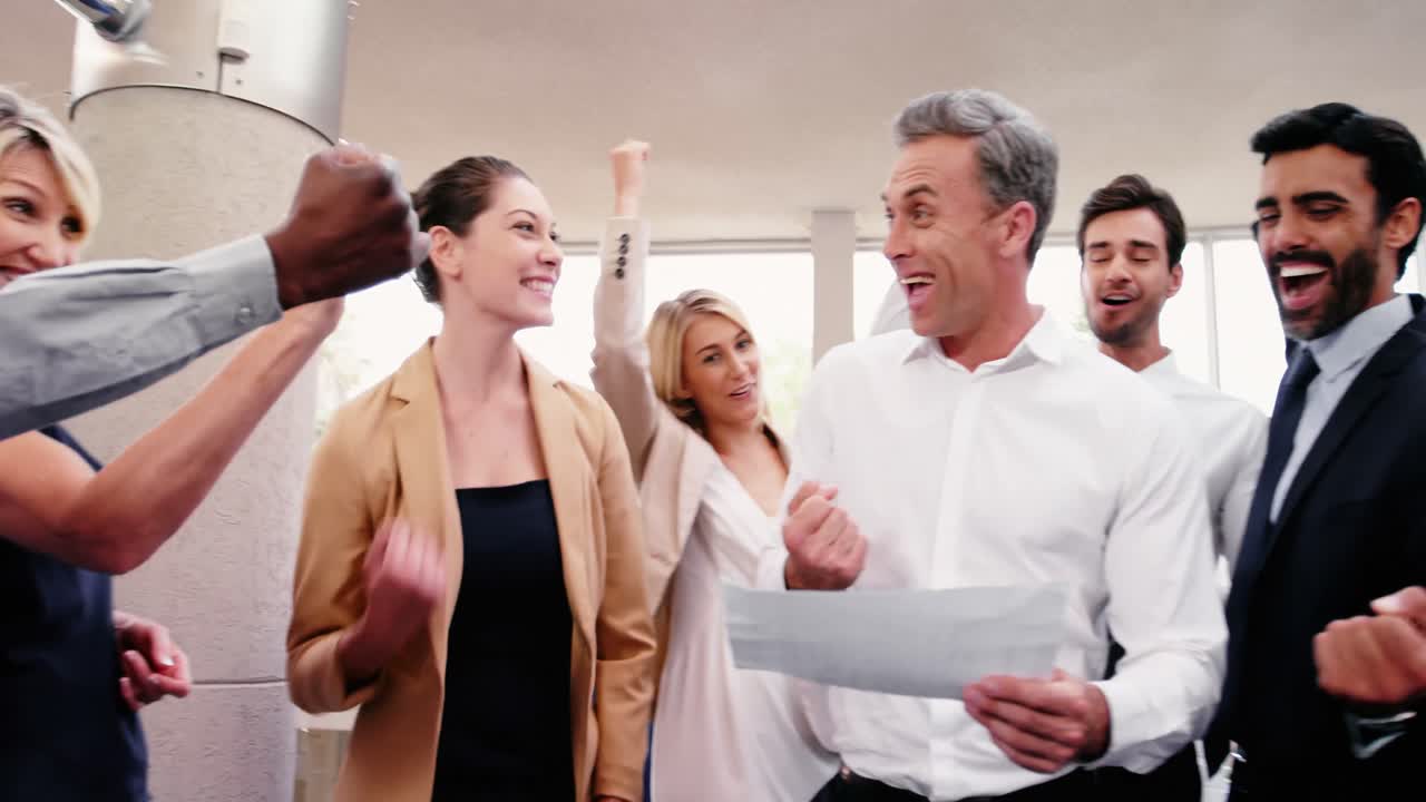 Happy business executives looking at report