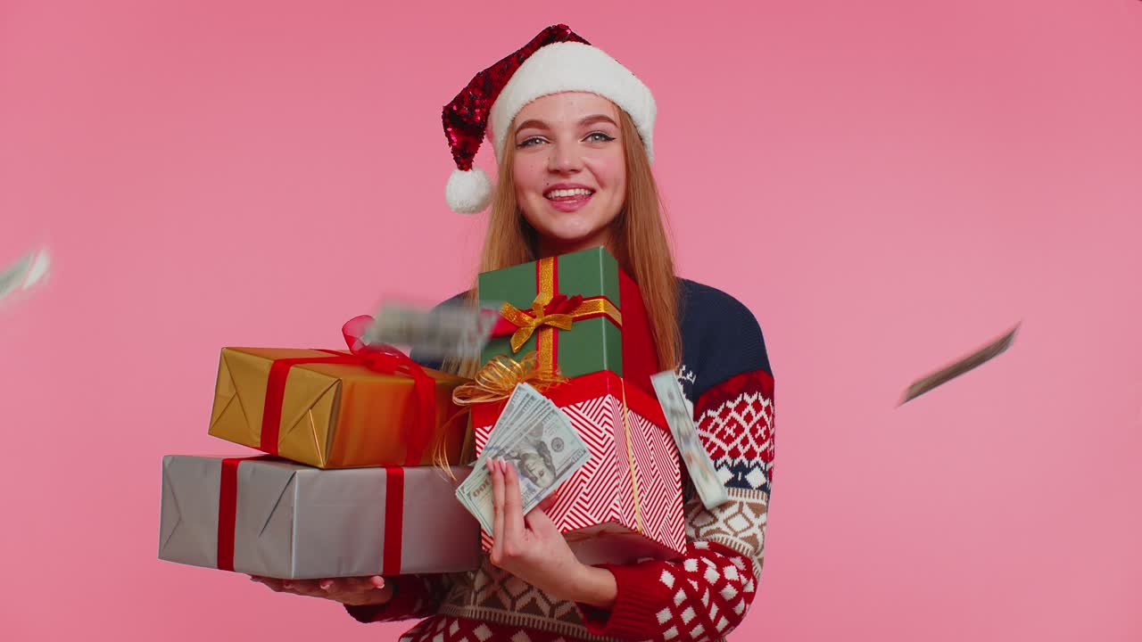 Christmas girl holding gift boxes concept of spending money shopping online cash dollars falling