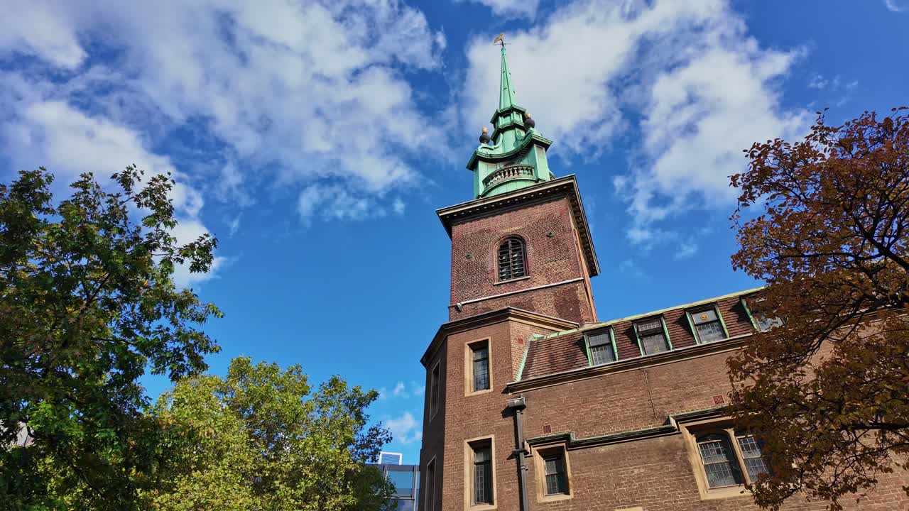 Panning movement to the All Hallows-by-the-Tower church in daytime, London, England.