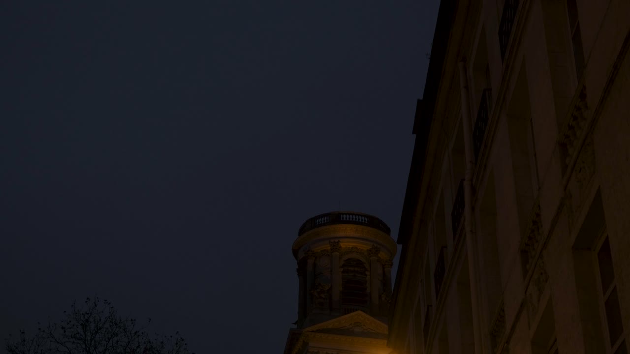 Night View of Saint-Sulpice Church Tower Illuminated from a Paris Street