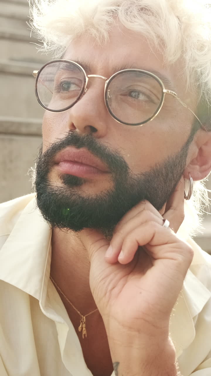 Close-up of Thoughtful Man with Bleached Hair and Glasses