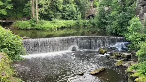 man made waterfall in the town of newmills in the derbyshire peak district