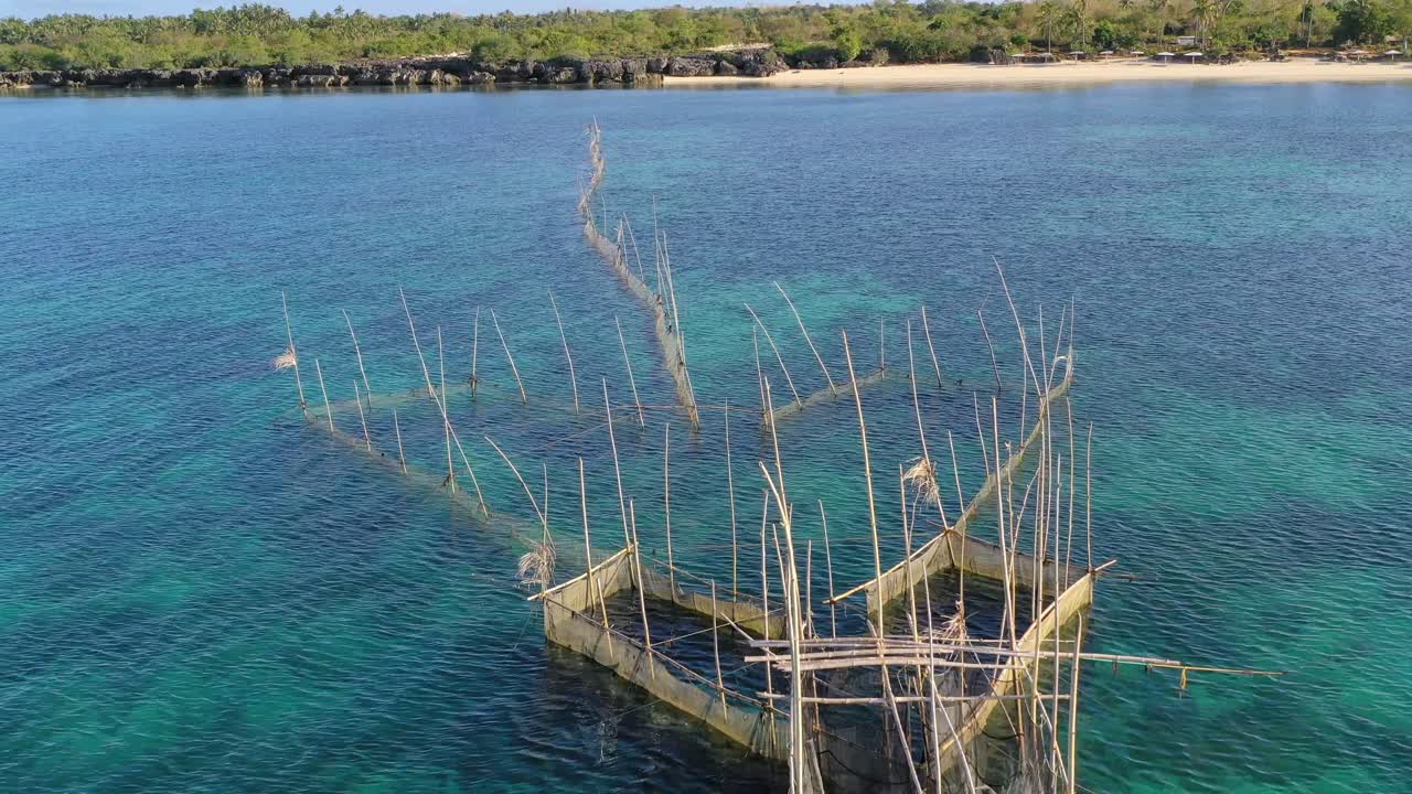 Fish cage built with fish net and bamboo on the idyllic sea of Boracay. Aerial