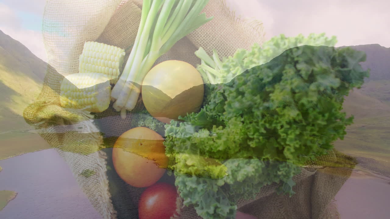 Fresh vegetables in burlap sack over scenic mountain landscape animation