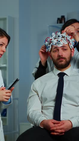 scientists conducting eeg brain research on a male patient
