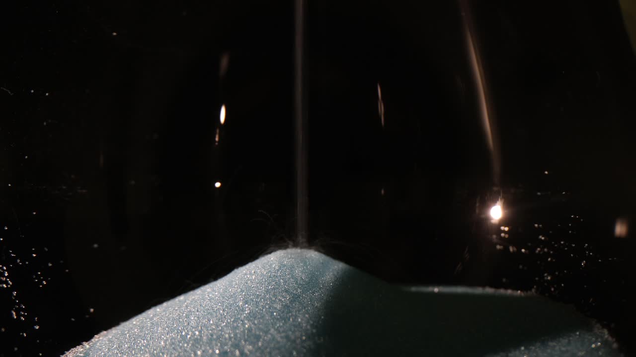 Close-up of Sand Flowing in an Hourglass