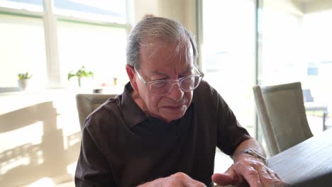 Elderly Man Using Laptop at Home