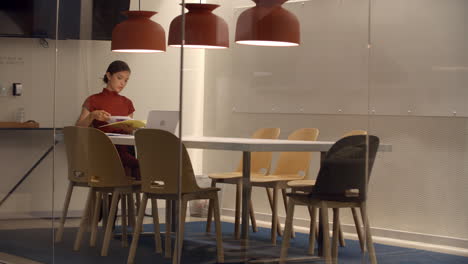 Businesswoman-working-alone-in-cubicle-at-corporate-business