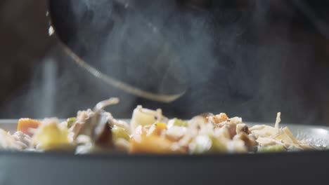 spoon stirring a hot bowl of hearty, homemade turkey and vegetable stew