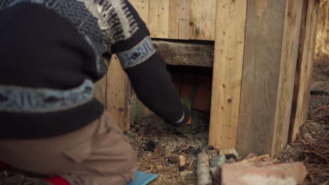 The-Man-is-Applying-Cement-to-Secure-the-Stove-Beneath-the-DIY-Hot-Tub---Close-Up