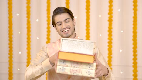 indian man with sweet boxes