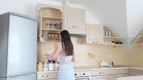 young woman cleans sunlit window in empty room