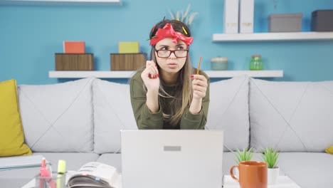 Cheerful-and-funny-schoolgirl-is-studying-at-home.