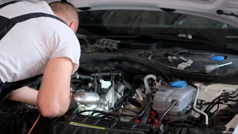 mechanic repairing car engine