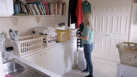 laundry room with a woman and multiple laundry baskets