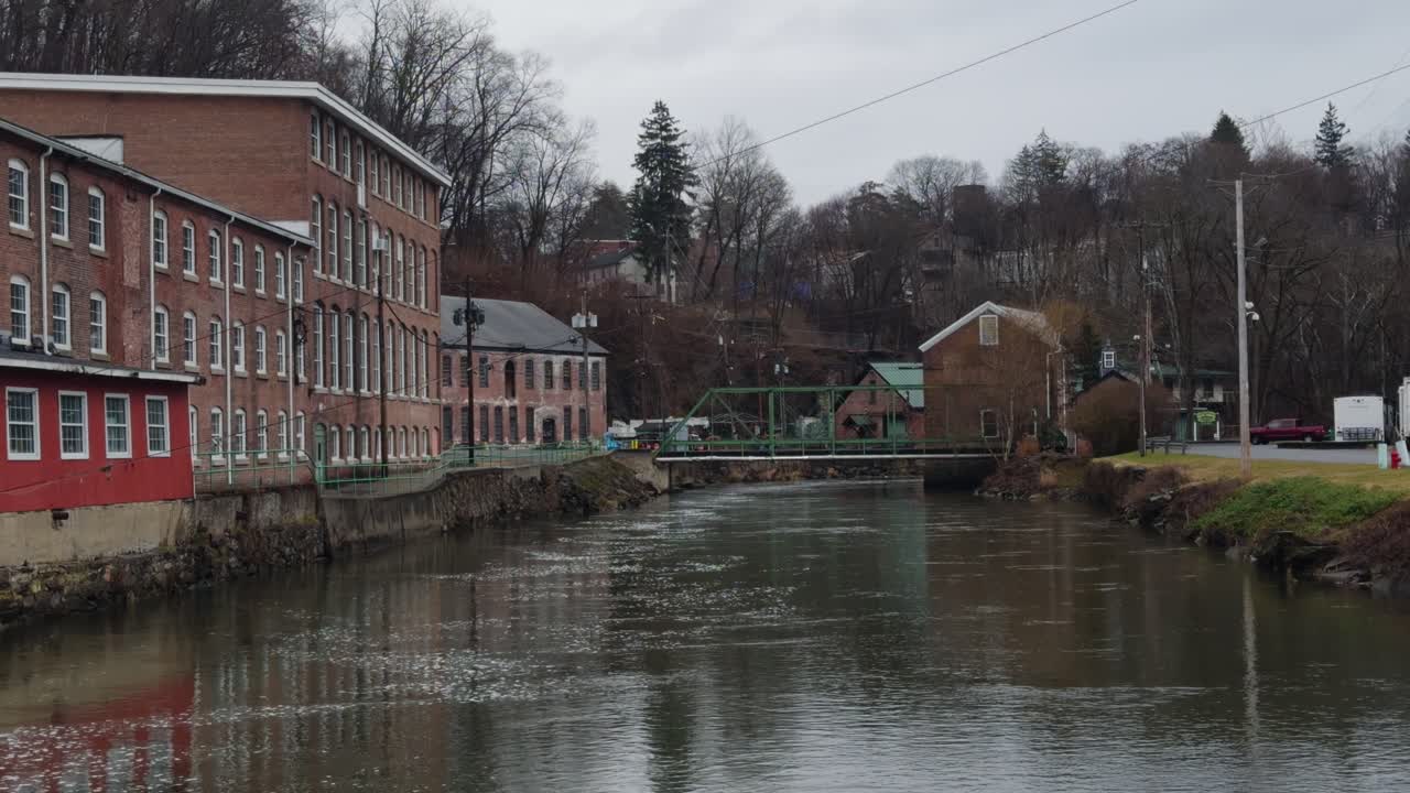 Old brick buildings in an industrial park with a creek in small town USA" Include keywords: Dutchess County, Wappingers Falls, and Wappingers Creek
