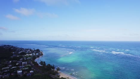 Aerial view of a tropical coastline with clear blue ocean