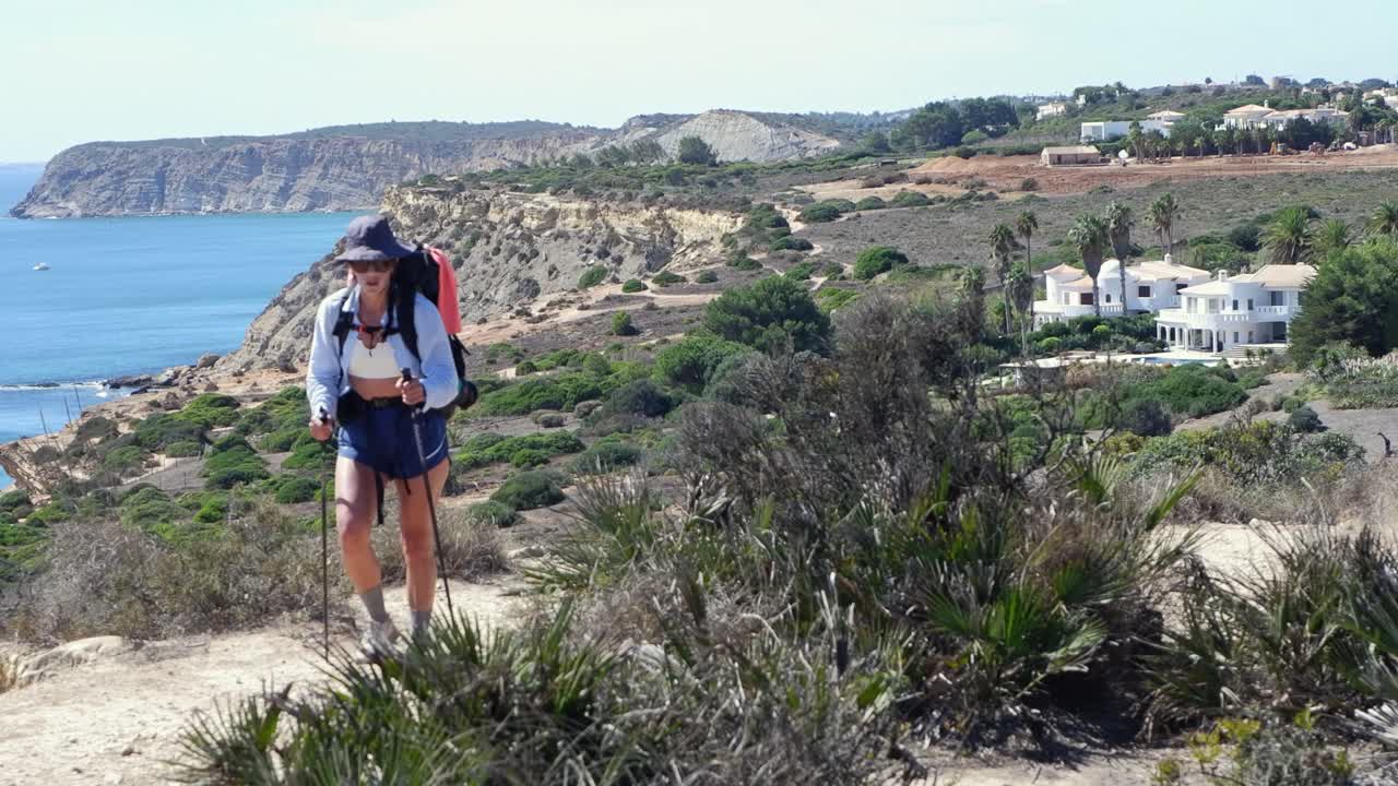 Female backpacker with hiking poles trekking on Fisherman's Trail PRT