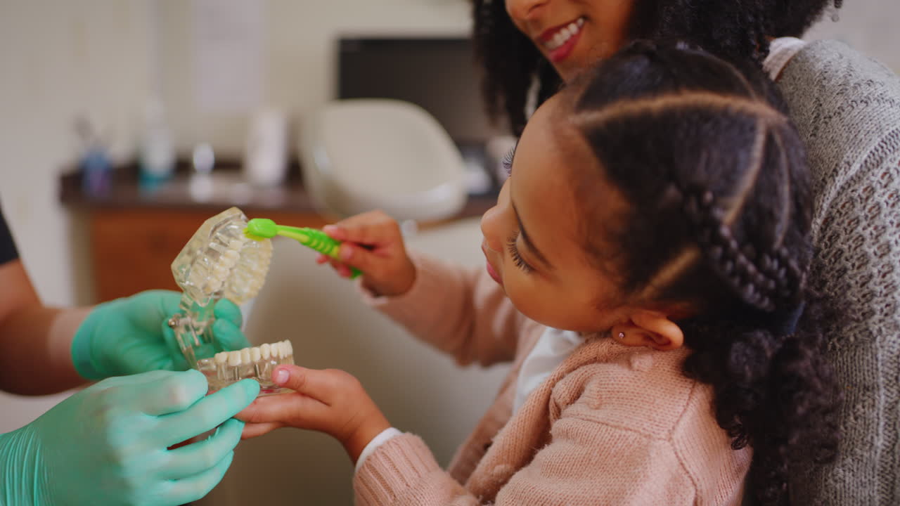 Dentist teaching a child about proper dental