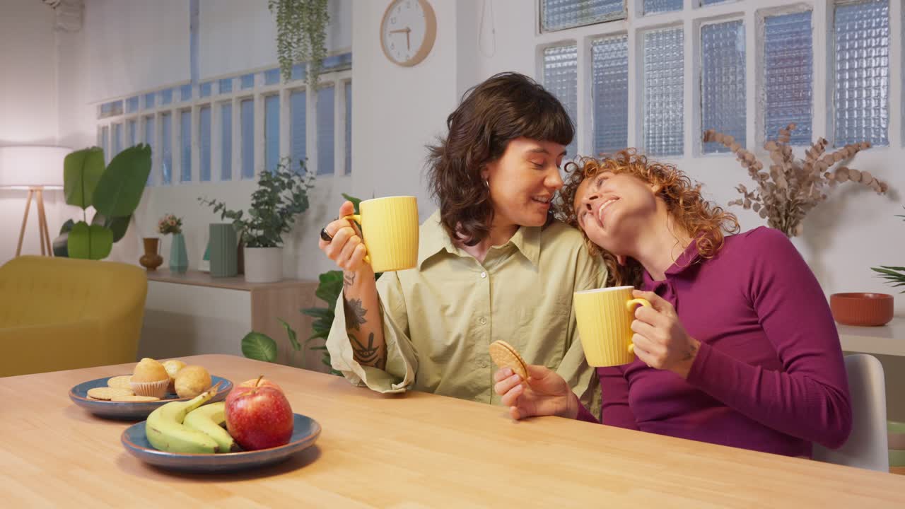 A lesbian couple having lunch at a table
