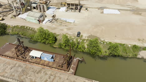 cargo ship docked by the arkansas river near sand and gravel pit in van buren, arkansas