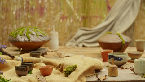 tea ceremony setup with hand holding teapot