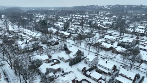 aerial flyover of a snow-covered american suburb