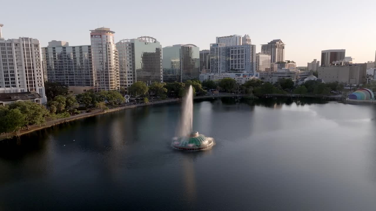 Downtown Orlando, Florida skyline with Linton E. Allen Memorial Fountain in Lake Eola and drone video pulling back.