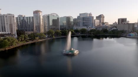 downtown orlando, florida skyline with linton e. allen memorial fountain in lake eola and drone video pulling back.