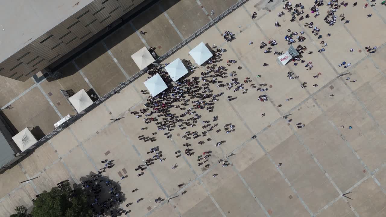 Aerial View of a Large Crowd of People Waiting in a Public Plaza