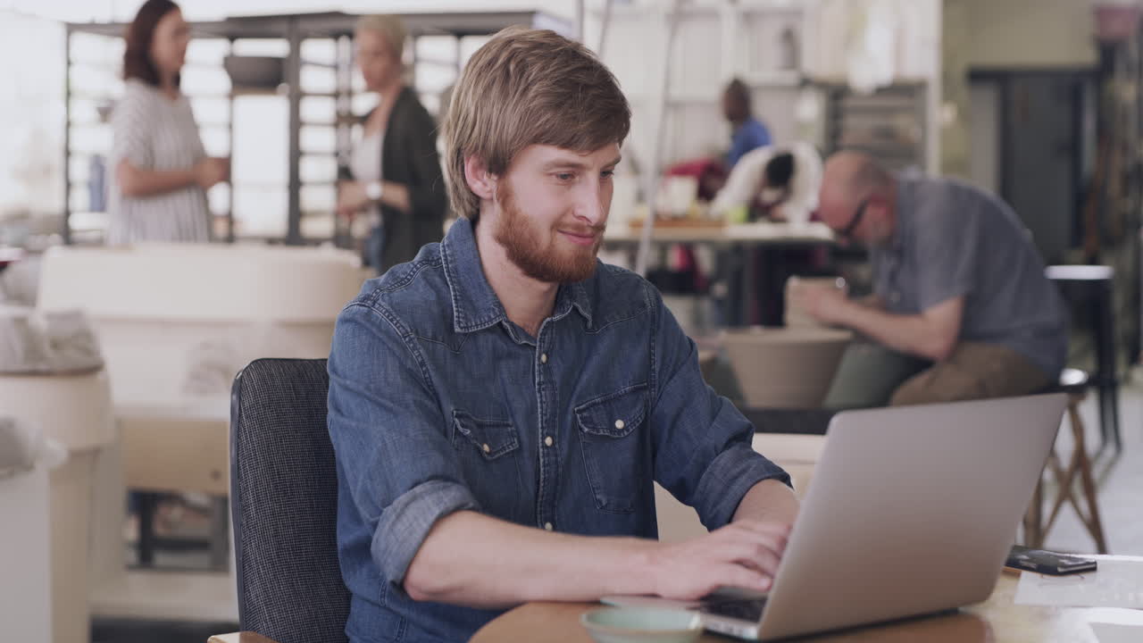 Man working on a laptop in an art studio