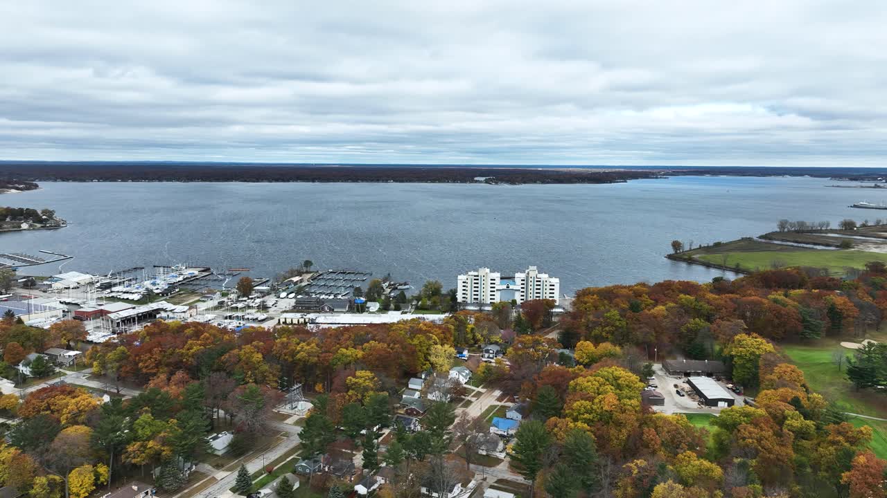 A high up aerial pan of Lake Michigan's coast in Fall