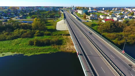 Aerial-view-of-city-road-over-river.-Sky-view-of-highway-road-in-city