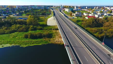 aerial view of city road over river. sky view of highway road in city