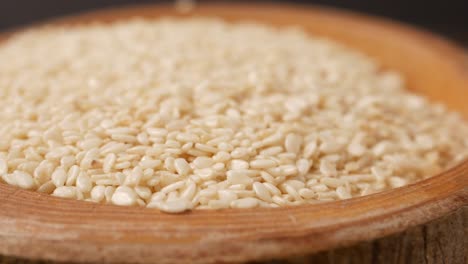 close up of a bowl of white sesame seeds