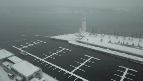 snowy winter in canada by the docks of an old town - drone 4k aerial