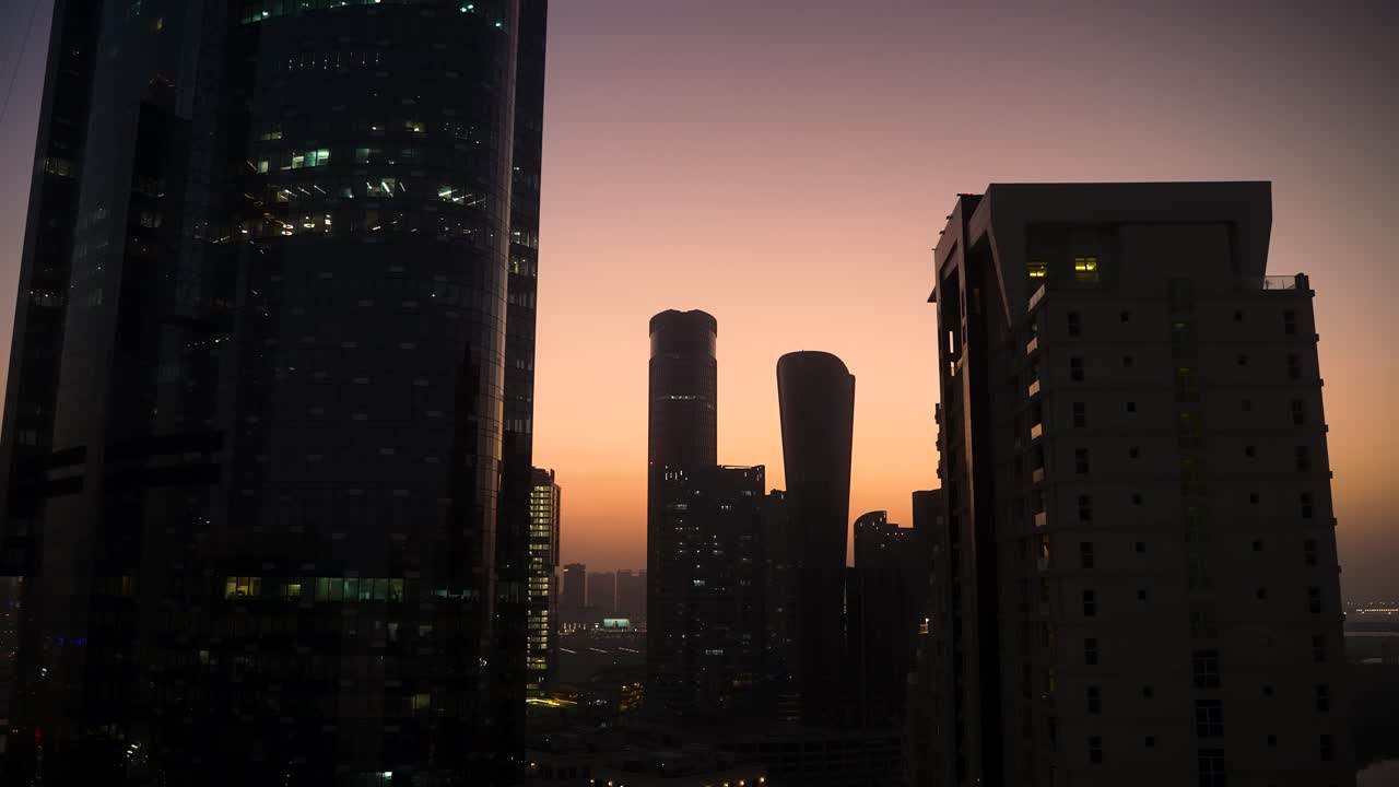 Steamy, hot, humid, hazy sunset to nighttime time lapse of Al Reem Island, Abu Dhabi UAE