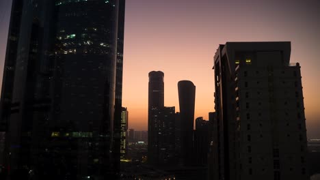 steamy, hot, humid, hazy sunset to nighttime time lapse of al reem island, abu dhabi uae