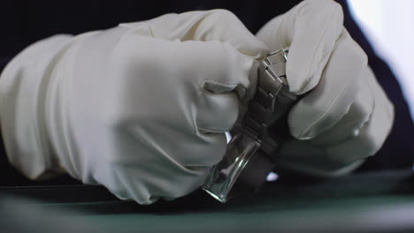 close-up footage of a professional watch collector attaching the steel bracelet to the luxury watch