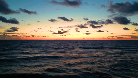 tropical golden sunset over ocean water slow motion aerial view