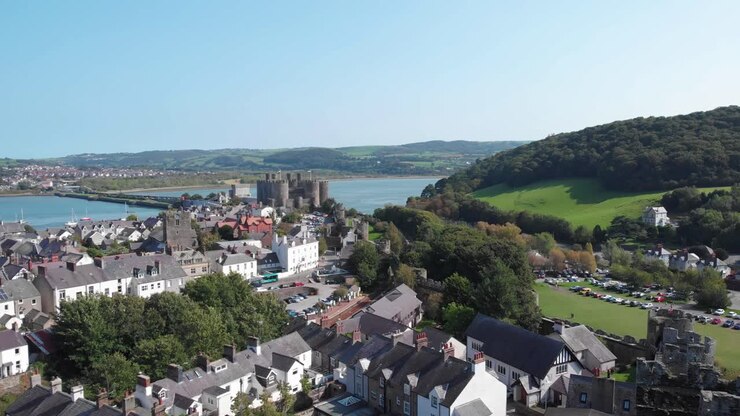 Drone flight over the ruins of Conwy castle and the town cottages, Wales