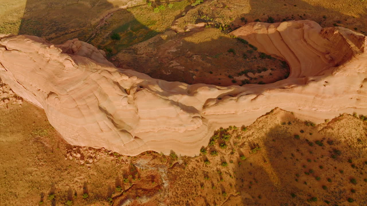 Rounded slopes of weird-shaped rock in Arches National park, Utah, USA. Aerial footage over the fantastic landscape.