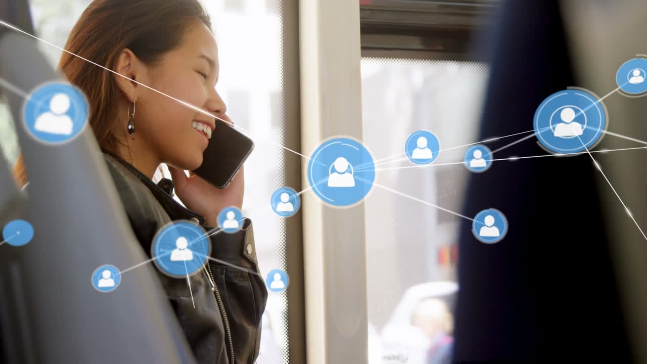 Animation of network of connections with icons over asian businesswoman talking on smartphone